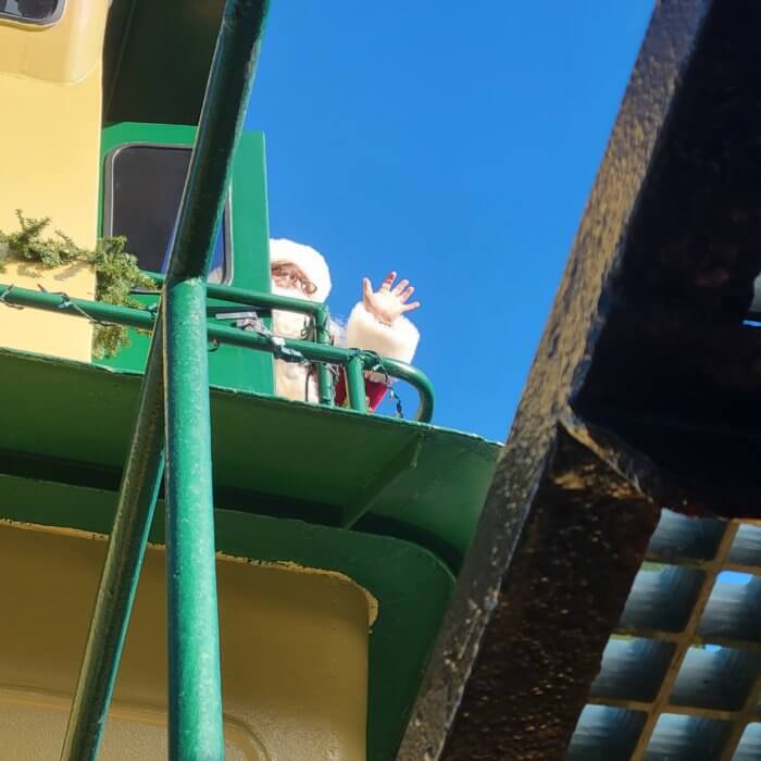 santa waves from a tug  boat