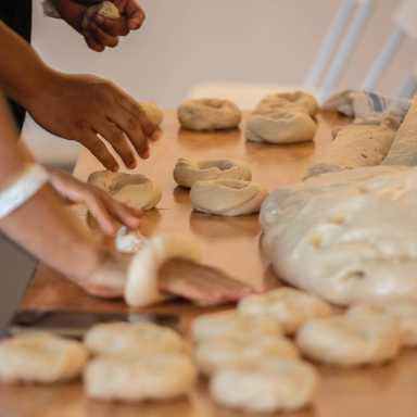 people making bagels by hand