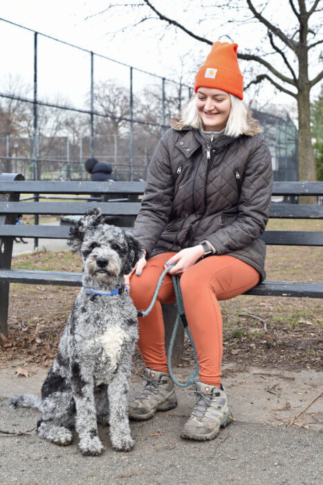 woman posing with dog in park