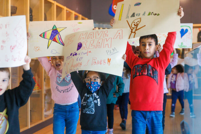 The children marched with personalized poster they created. 
