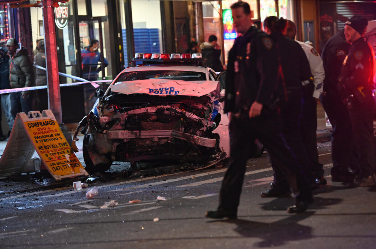An NYPD patrol car mounted the sidewalk after the crash on Friday night.