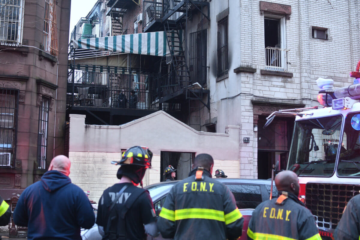 firefighters outside a 2-alarm williamsburg fire at 265 penn street