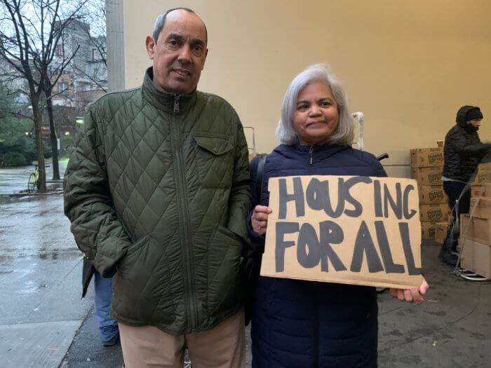 people posing with housing for all sign at bedford gardens