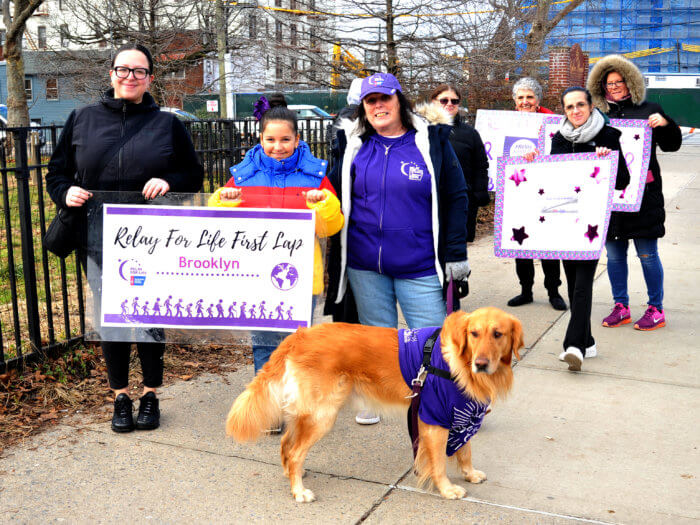 people with signs for first lap relay for life