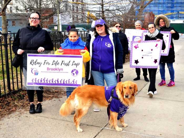 people with signs for first lap relay for life