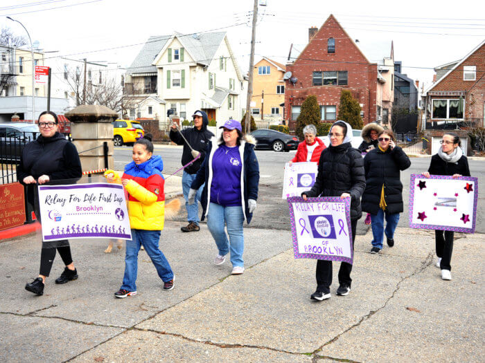people with signs for relay for life first lap