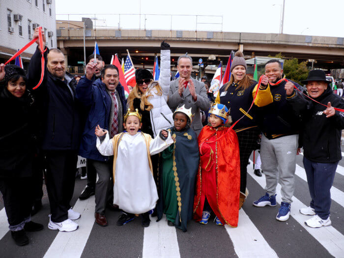crowd of people with kids dressed in robes for three kings day