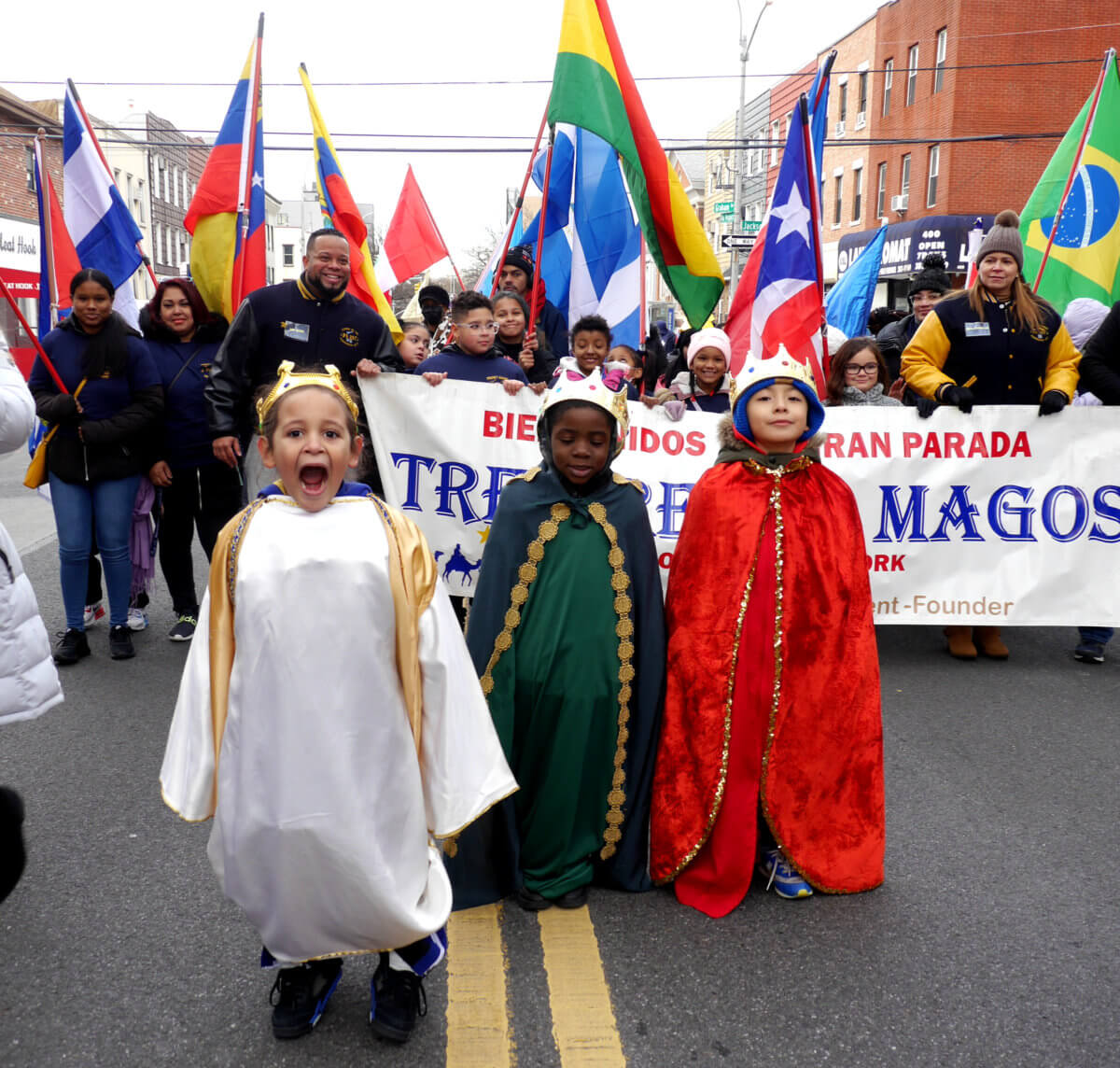 kids pressed in capes lead three kings day parade