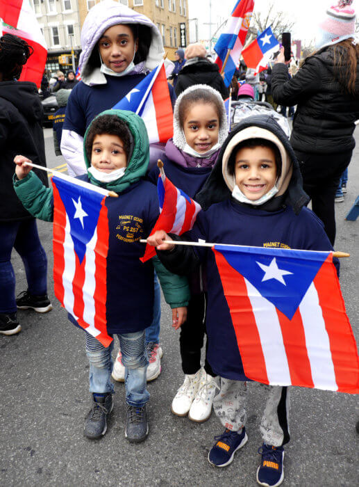 kids with puerto rican flags at three kings day parade