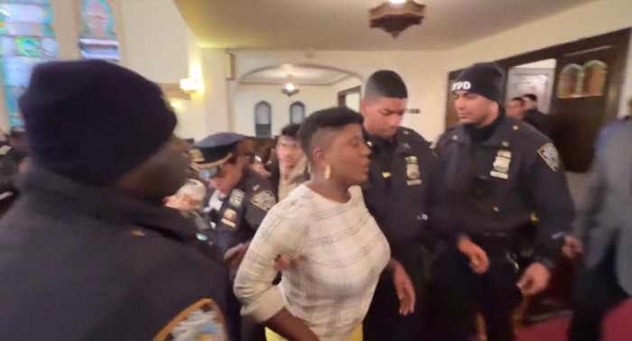 woman being removed from sunset park church during visit from hochul