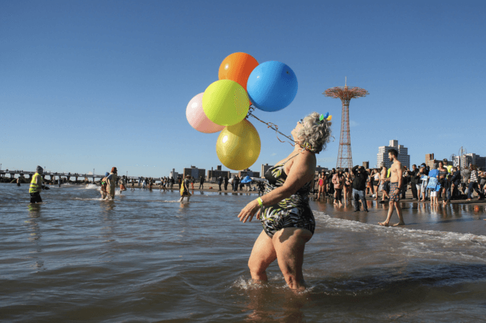 woman at coney island polar bear plunge with balloons