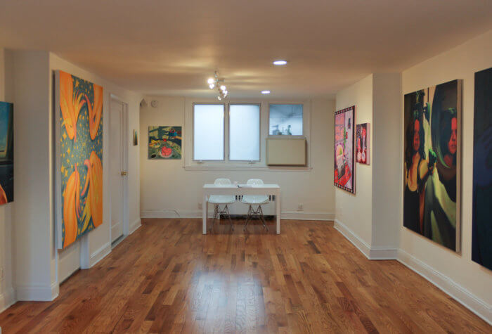 inside of tchotchke gallery with paintings on the wall