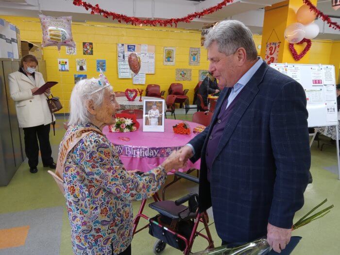 Brook-Krasny presents Bigelson with flowers for 103rd birthday