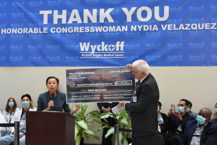 Congress Member Nydia Velazquez, center, and Ramon Rodriguez, left, smile with Wyckoff Height Medical Center doctors and nurses on Thursday.