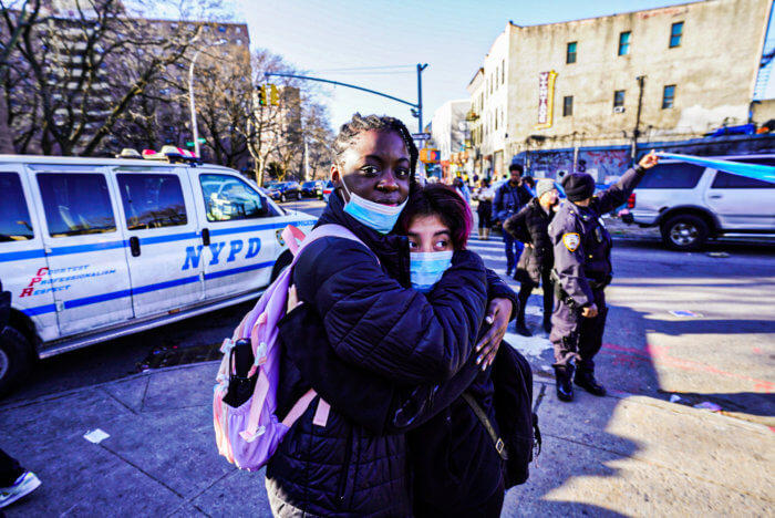 students embrace outside williamsburg high school after shooting