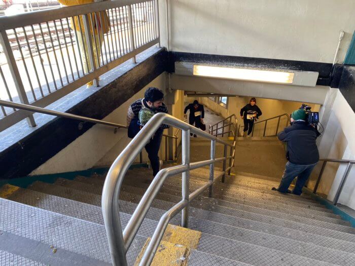 people racing up the stairs at subway station