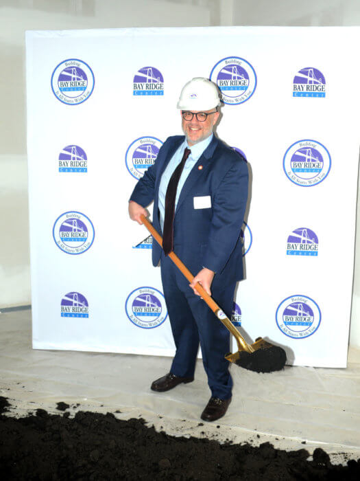 Council Member Justin Brannan, who represents Bay Ridge, poses at the groundbreaking for the Bay Ridge Center. 