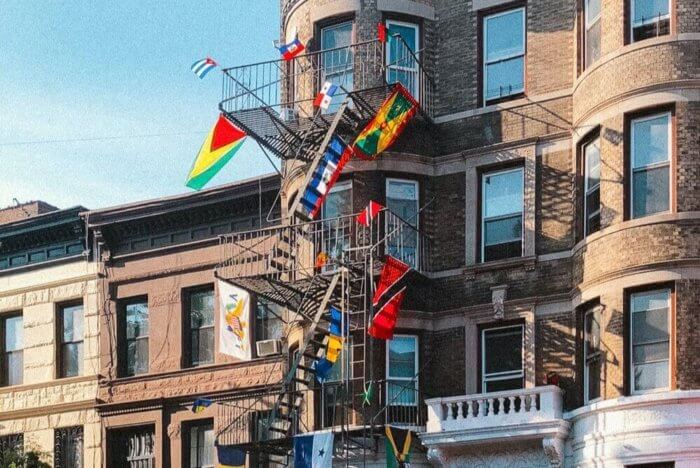 building with caribbean flags in little caribbean, near proposed guyana avenue co-naming
