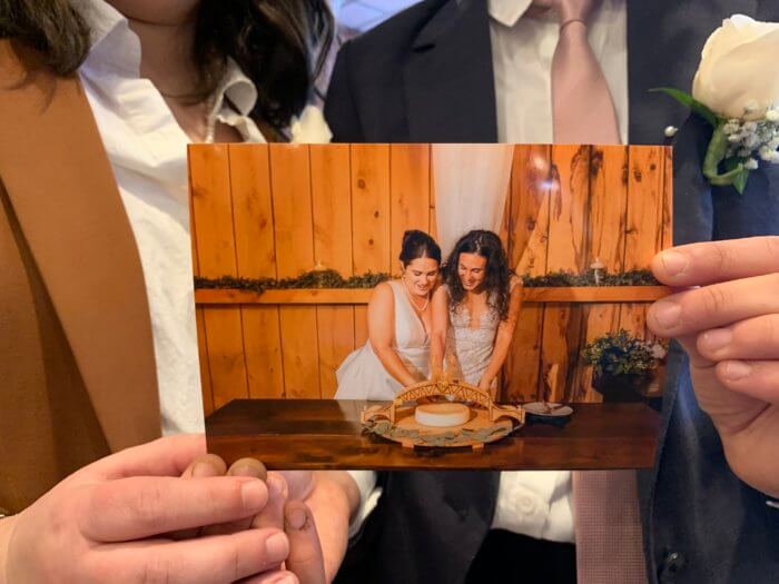 couple holding up a wedding photo