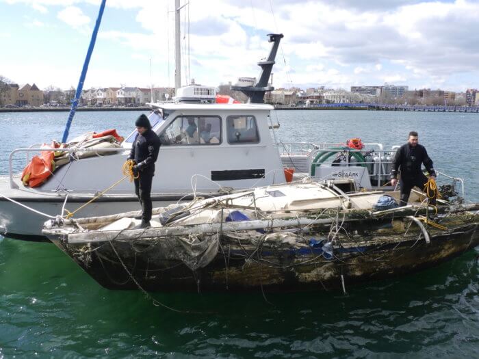 Parks Department divers help fish out boats from the depths of Sheepshead Bay.