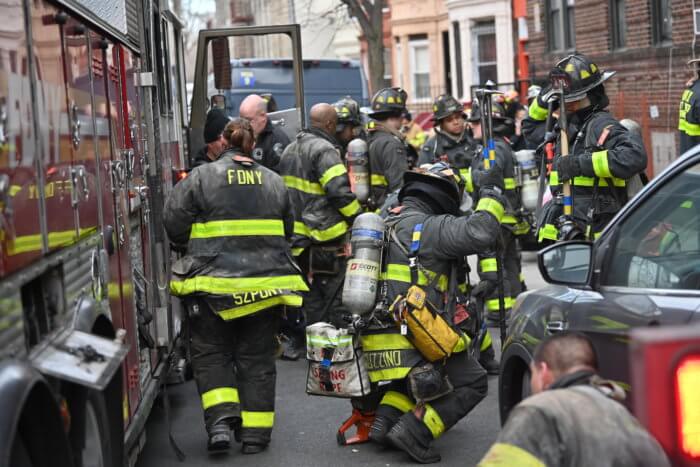 FDNY personnel gather at the scene in Crown Heights.