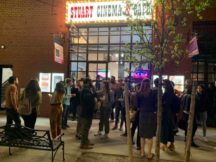 People gather outside the Stuart Cinema cafe for a film festival