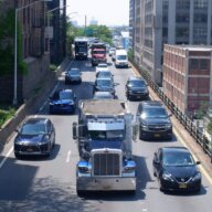 Cars and trucks travel along the BQE.