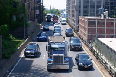 Cars and trucks travel along the BQE.