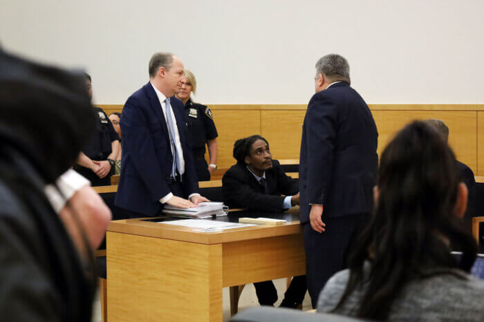sheldon thomas shaking hands with eric gonzalez after murder conviction overturned