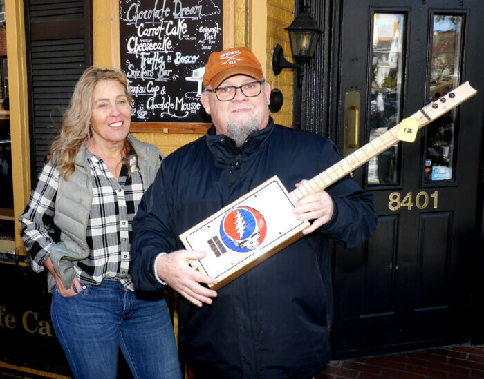 One creative, Patrick Hamilton, shows off a hand made guitar that were on display inside Cafe Cafe.
