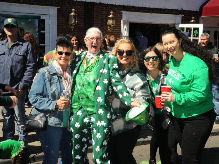Parade-goers clad in all green pose for a photo at the Bay Ridge St. Patrick's Day parade.
