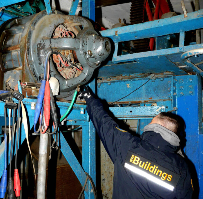 One inspection points out the gears on Deno's oldest ride, the Wonder Wheel.