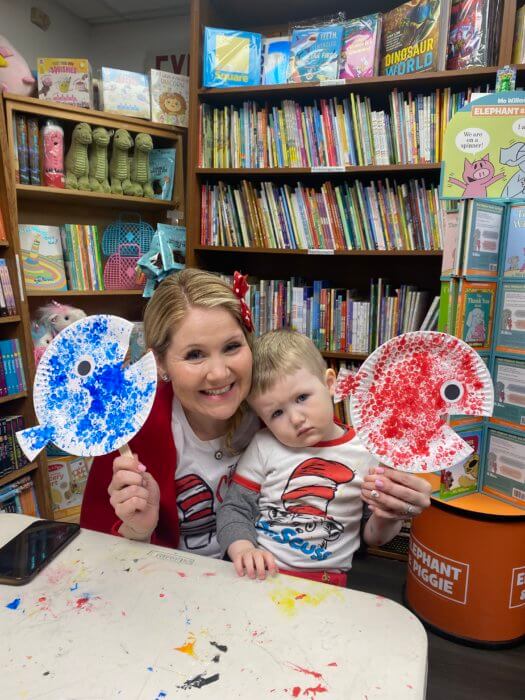 woman poses with kid at dr. seuss day celebration