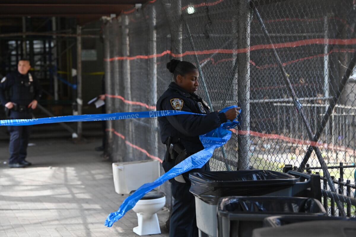 Police canvas the scene of the Monday morning shooting in Fort Greene.