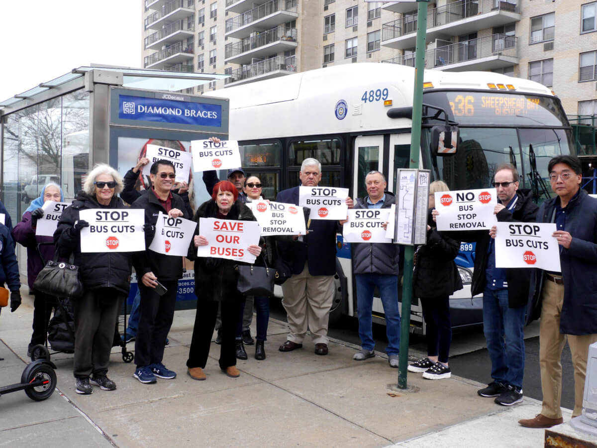Protestors gather and hold signs outside of a bus stop in Sheepshead Bay. 3/2/2023