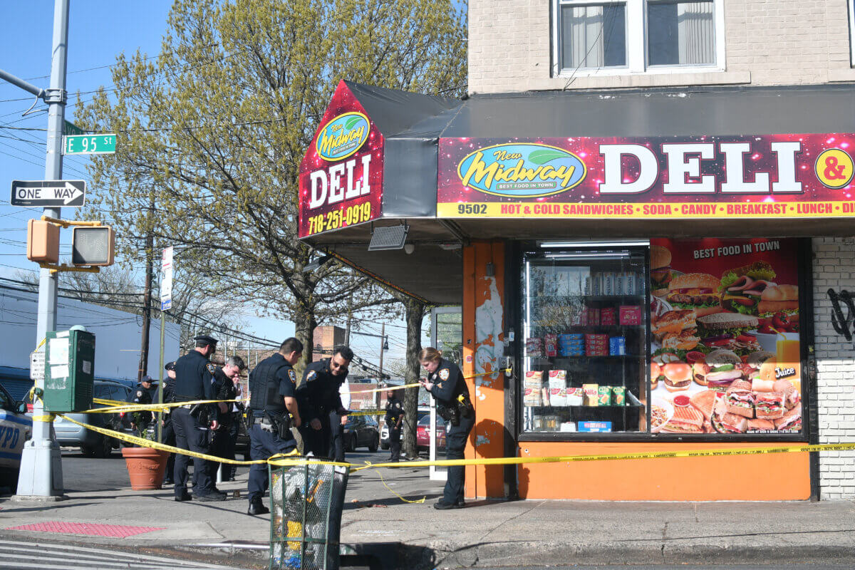 Police investigate the scene where a gunman fatally shot a man in Canarsie.