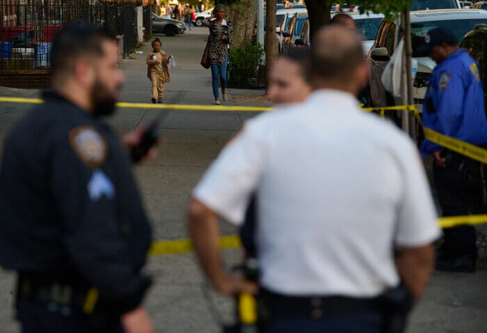 people walking on road after double shooting