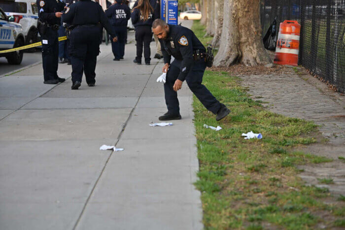 Officers place gloves as evidence markers after the shooting at Flatlands Avenue and Louisiana Avenue.