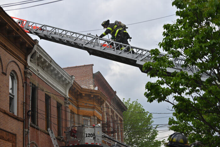 firefighter on ladder in east new york