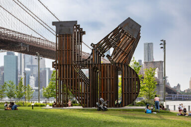 Nicholas Galanin's sculpture in Brooklyn Bridge Park, titled 'In every language there is Land / En cada lengua hay una Tierra.'