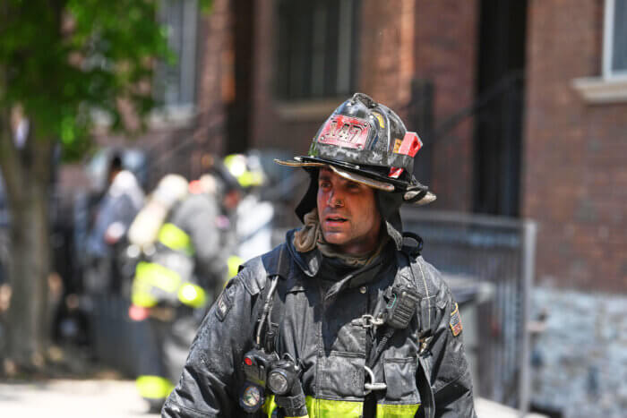 A firefighter is covered in soot and grim after operating at the all hands fire.