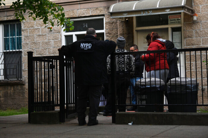 An NYPD Arson and Explosion Detective interviews residents after the fatal fire
