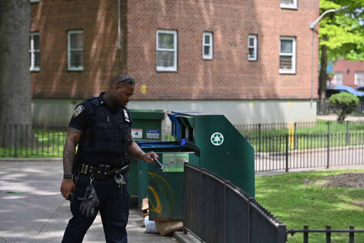 Police inspect the scene of the shooting in Canarsie.