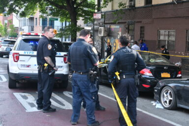 Police case the scene of the shooting in Crown Heights on the morning of May 19.