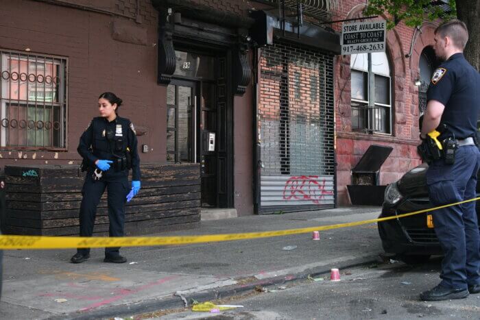 Police look for evidence at the scene in Crown Heights.