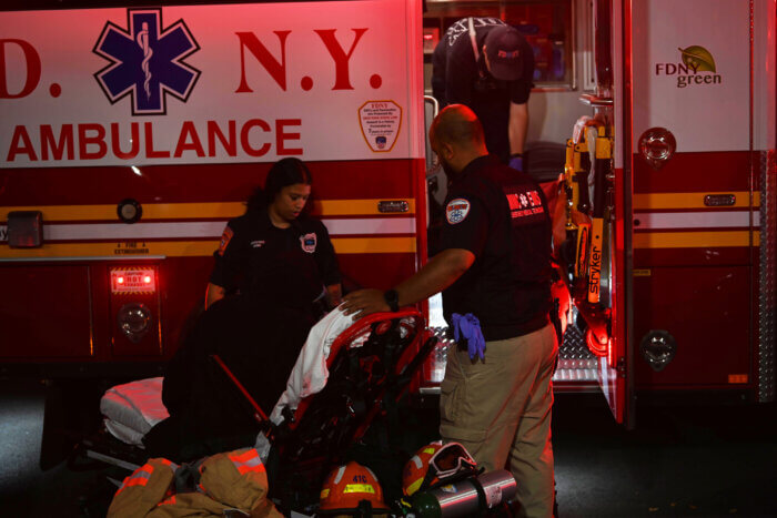 Paramedics tend to a man injuried during the two alarm fire