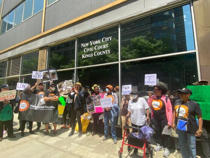 Tenants of 1111 Ocean Avenue chant "Evictions are violent, we will not be silent" as they rally in support of their neighbor.