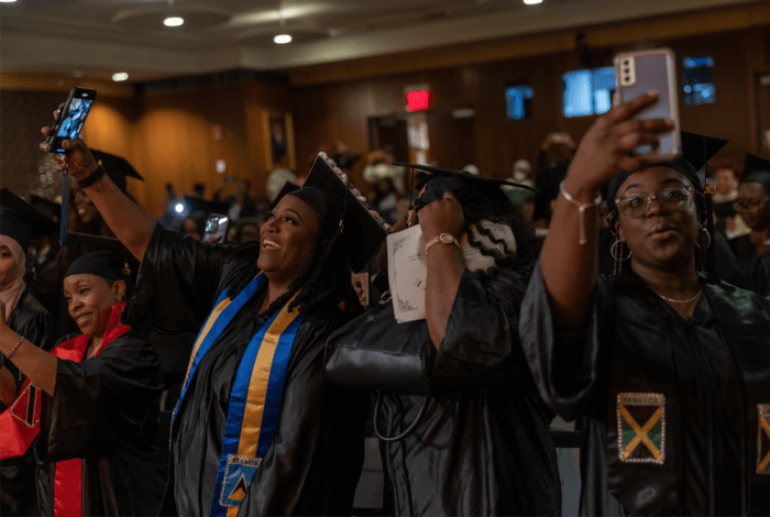 Graduates posed in their cap and gown moments before getting their diploma.