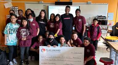 teaching excellence award winner with students and check