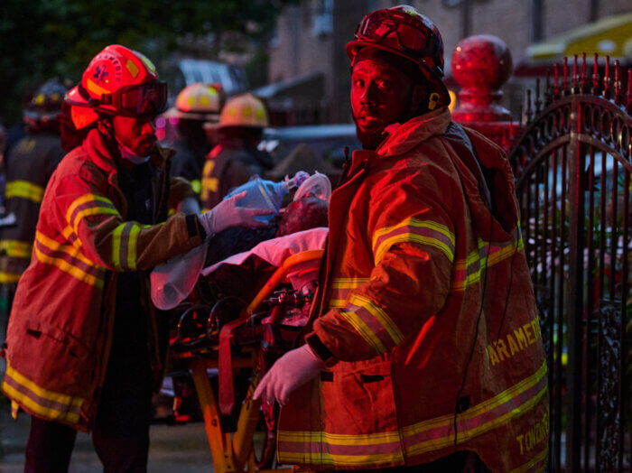Paramedics work to treat a fire victim during a house fire at 576 Junius Street in Brownsville, Brooklyn on Sunday, July, 9th.